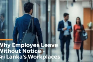 A man in a suit walks through a modern office hallway, with two colleagues in the background engaged in conversation.