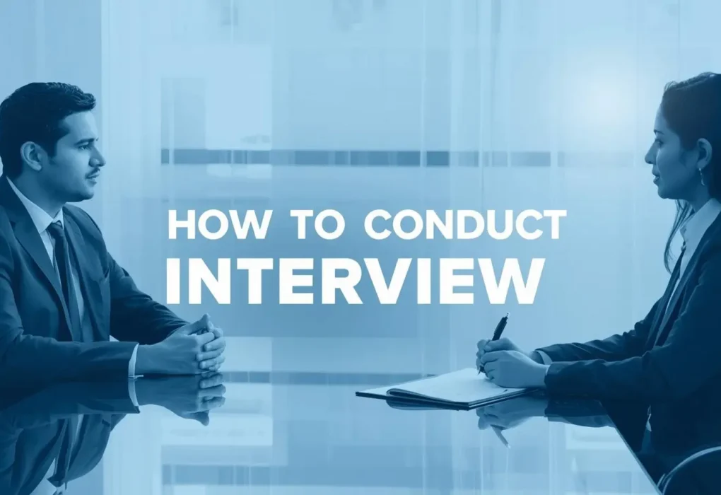 A man and woman in business attire sit across a table, engaged in conversation. Text reads "How to Conduct Interview." The tone is professional and focused.