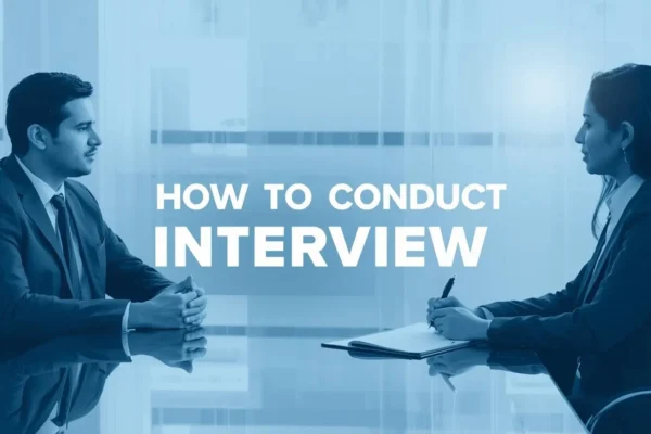 A man and woman in business attire sit across a table, engaged in conversation. Text reads "How to Conduct Interview." The tone is professional and focused.